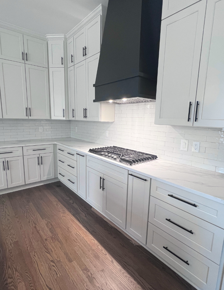 White subway tile backsplash with quartz countertops installed by Top Floors Carpet One in a Gwinnett County kitchen