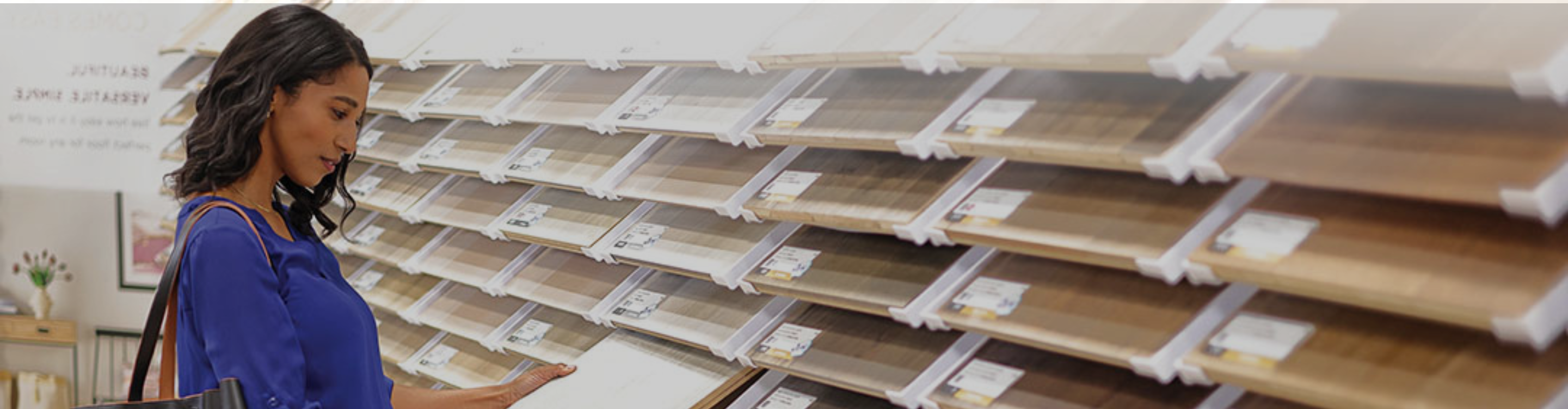 Client browsing hardwood and luxury vinyl flooring samples at Top Floors Carpet One showroom in Suwanee GA