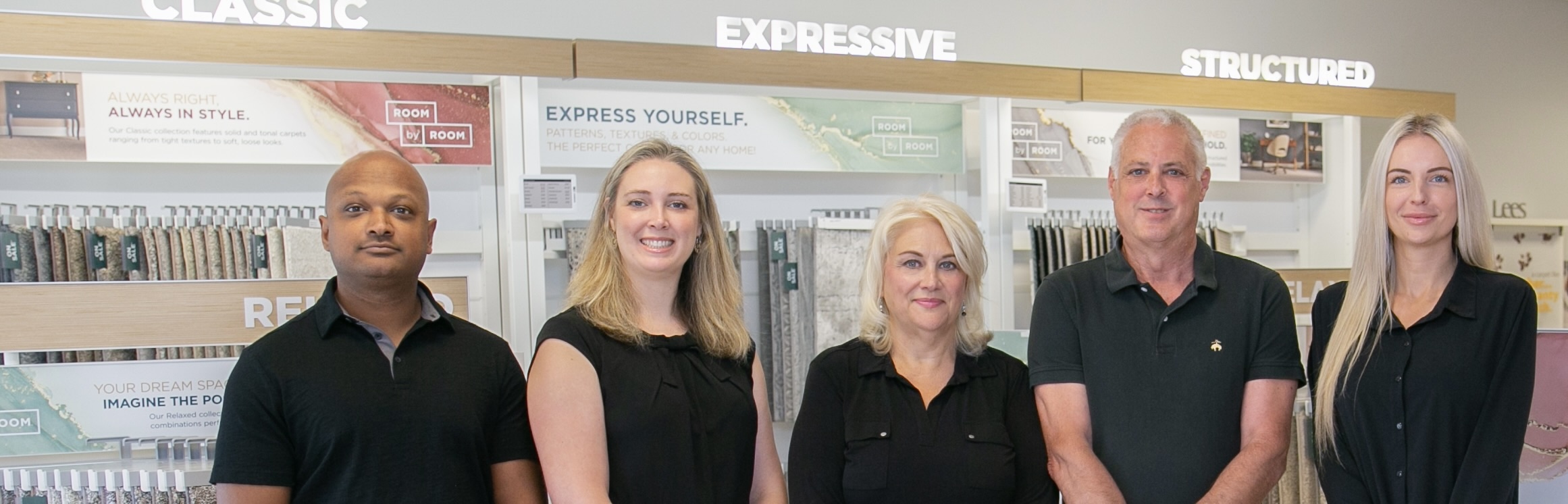 Top Floors Carpet One team photo: owners Dan and Becky Clough with their daughter Michelle Ali, her husband Keith, and sales associate Sabrina Sinanovic. Family-owned business leadership standing toge
